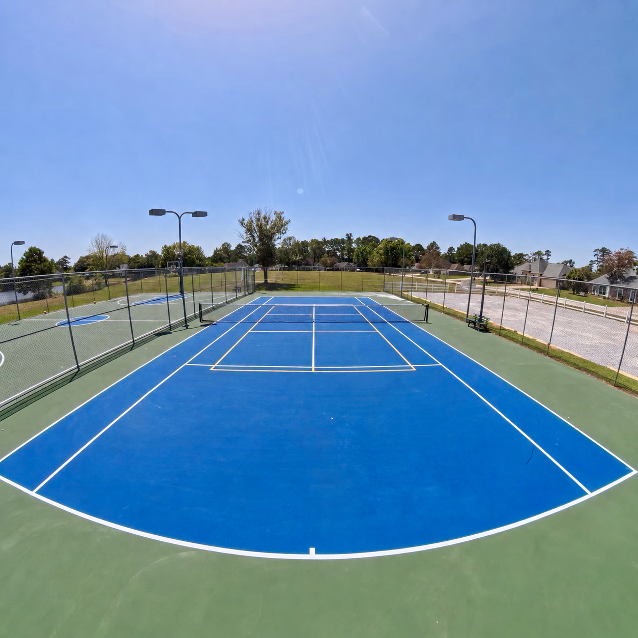 Tennis court viewed from the opposite baseline